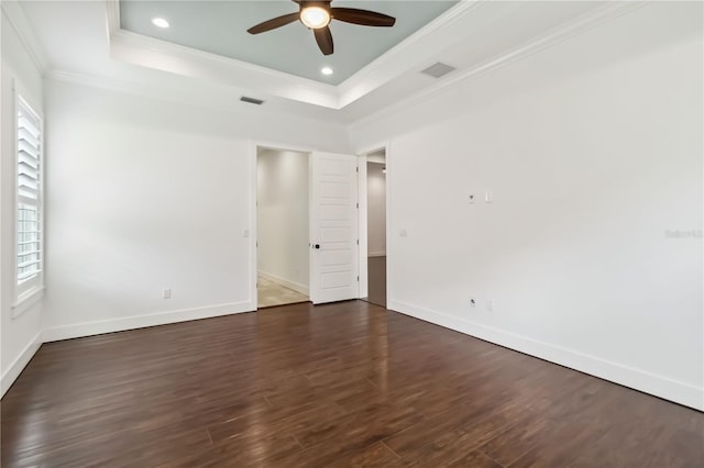 1015 143rd St NE, Bradenton, FL 34212 - spare room featuring a raised ceiling, crown molding, a ceiling fan, healthy amount of natural light, and dark wood-style flooring