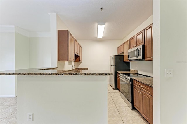 4802 51st St W Unit 808, Bradenton, FL 34210 - kitchen featuring stainless steel appliances, light tile patterned flooring, dark stone countertops, a sink, and a peninsula