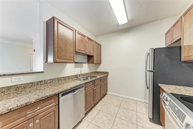 4802 51st St W Unit 808, Bradenton, FL 34210 - kitchen with stainless steel appliances, a sink, baseboards, light stone counters, and crown molding