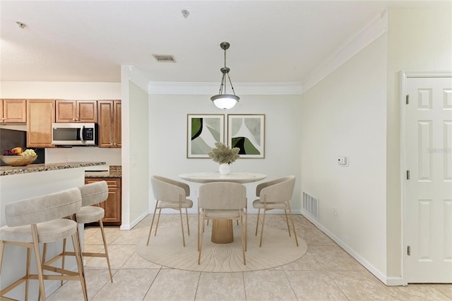 4802 51st St W Unit 808, Bradenton, FL 34210 - dining room with crown molding, light tile patterned floors, and baseboards