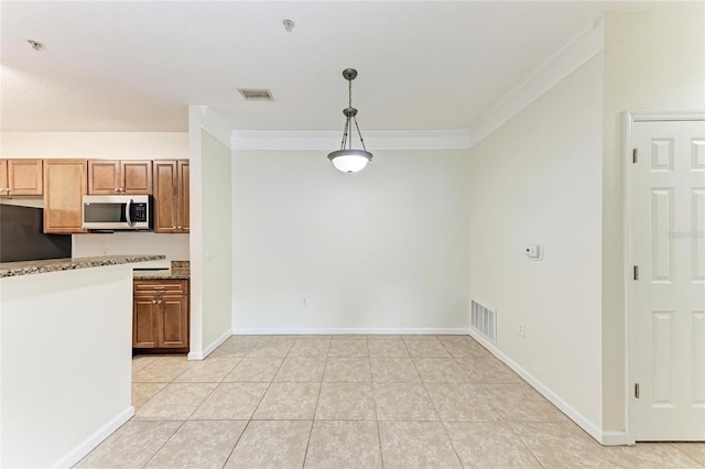 4802 51st St W Unit 808, Bradenton, FL 34210 - kitchen with stainless steel microwave, ornamental molding, light tile patterned flooring, pendant lighting, and baseboards