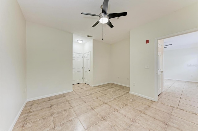 4802 51st St W Unit 808, Bradenton, FL 34210 - empty room with a ceiling fan, light tile patterned flooring, and baseboards