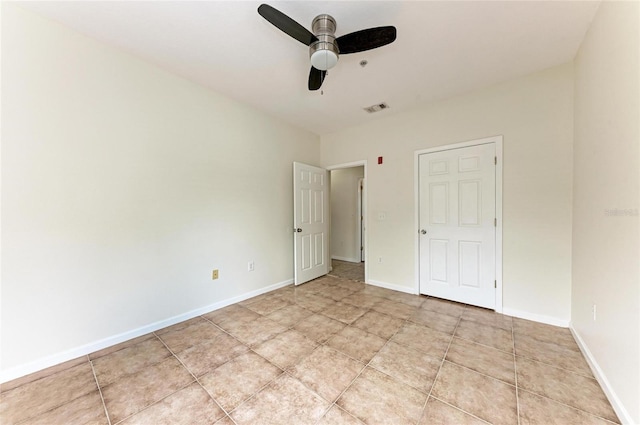 4802 51st St W Unit 808, Bradenton, FL 34210 - unfurnished bedroom featuring ceiling fan, baseboards, and light tile patterned floors