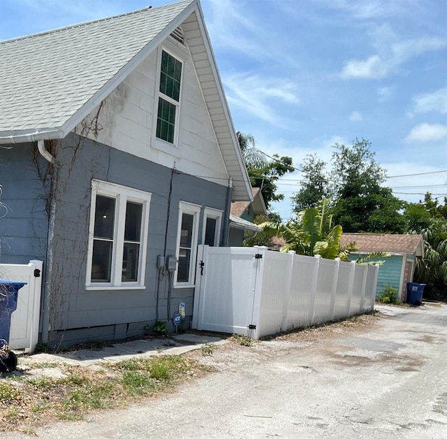 783 30th Ave N, Saint Petersburg, FL 33704 - view of property exterior with a shingled roof and a gate