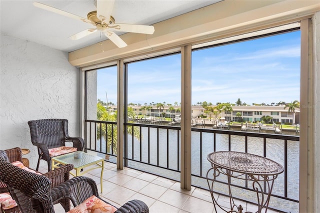 4210 SE 20th Pl Unit A8, Cape Coral, FL 33904 - sunroom / solarium featuring a water view, a textured wall, plenty of natural light, tile patterned flooring, and a residential view