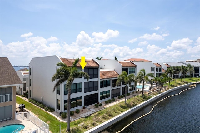 4210 SE 20th Pl Unit A8, Cape Coral, FL 33904 - rear view of house with a residential view, a tile roof, stucco siding, and a water view