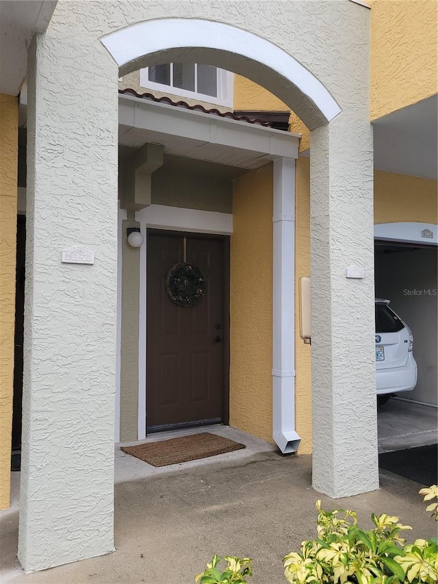 5459 Bentgrass Dr Unit 2-116, Sarasota, FL 34235 - view of exterior entry featuring stucco siding