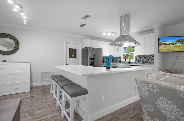 3861 N Ringdove Pt, Crystal River, FL 34428 - kitchen with high end fridge, island exhaust hood, decorative backsplash, white cabinetry, and a kitchen island