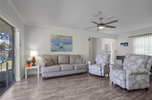 3861 N Ringdove Pt, Crystal River, FL 34428 - living area with plenty of natural light, wood finished floors, ornamental molding, and a ceiling fan
