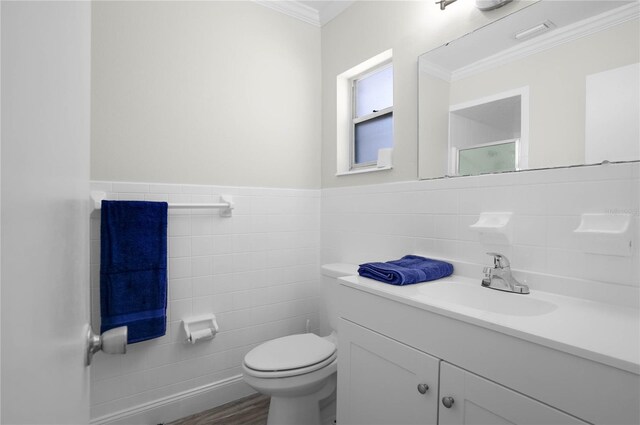 3861 N Ringdove Pt, Crystal River, FL 34428 - bathroom featuring tile walls, vanity, toilet, crown molding, and wood finished floors