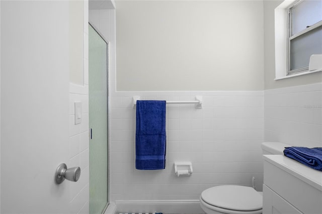 3861 N Ringdove Pt, Crystal River, FL 34428 - bathroom featuring tile walls, toilet, a shower stall, wainscoting, and vanity