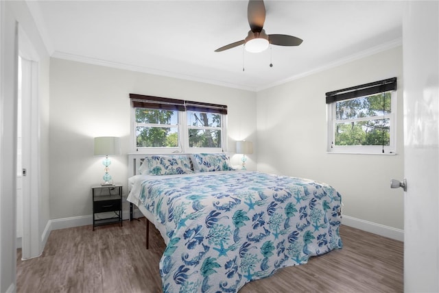 3861 N Ringdove Pt, Crystal River, FL 34428 - bedroom with baseboards, multiple windows, wood finished floors, and ornamental molding