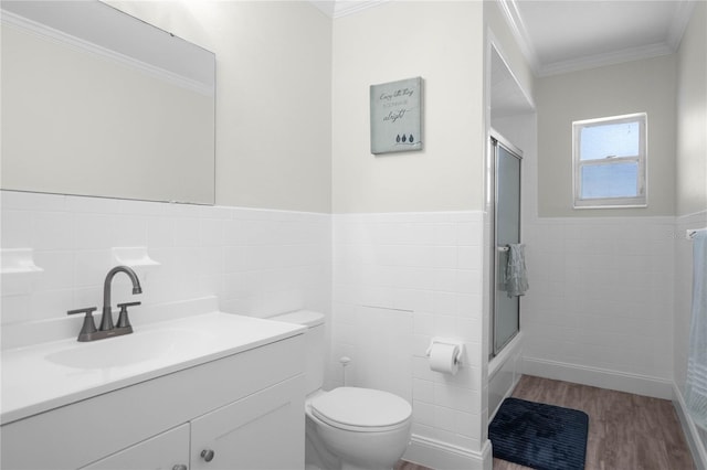 3861 N Ringdove Pt, Crystal River, FL 34428 - full bathroom with tile walls, toilet, ornamental molding, vanity, and wood finished floors