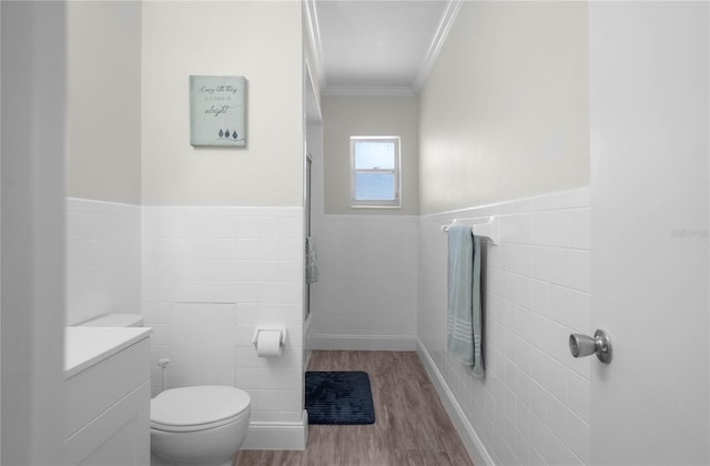 3861 N Ringdove Pt, Crystal River, FL 34428 - bathroom with tile walls, crown molding, wood finished floors, toilet, and a shower