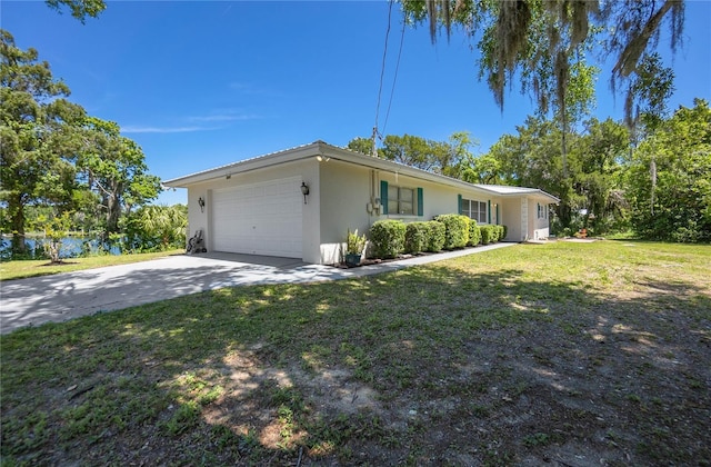 3861 N Ringdove Pt, Crystal River, FL 34428 - view of front of house with an attached garage, stucco siding, a front yard, and driveway