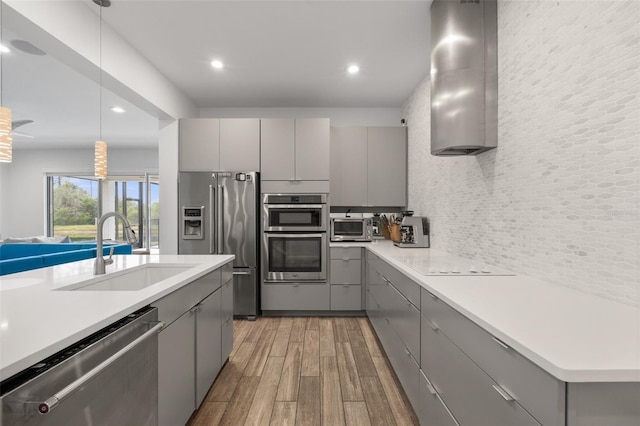 5240 Bentgrass Way, Bradenton, FL 34211 - kitchen featuring gray cabinets, appliances with stainless steel finishes, a sink, light wood-style floors, and recessed lighting
