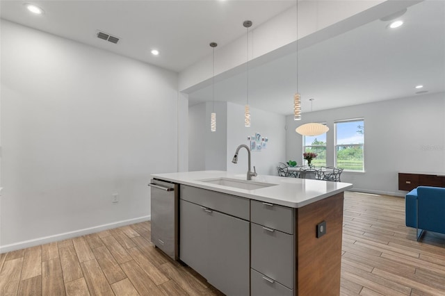 5240 Bentgrass Way, Bradenton, FL 34211 - kitchen with a sink, light wood-type flooring, a kitchen island with sink, stainless steel dishwasher, and recessed lighting