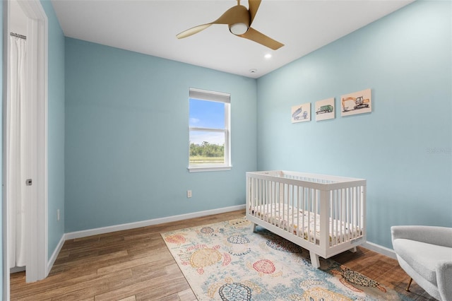 5240 Bentgrass Way, Bradenton, FL 34211 - bedroom featuring wood finished floors, baseboards, a nursery area, a ceiling fan, and recessed lighting