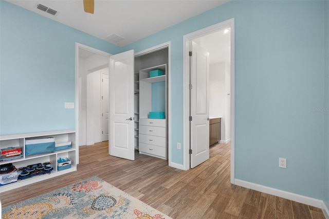 5240 Bentgrass Way, Bradenton, FL 34211 - bedroom featuring wood finished floors, baseboards, a closet, and ceiling fan