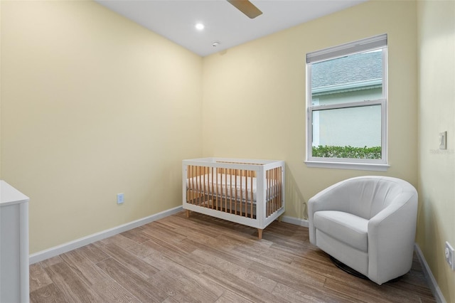 5240 Bentgrass Way, Bradenton, FL 34211 - bedroom with wood finished floors, baseboards, a nursery area, a ceiling fan, and recessed lighting