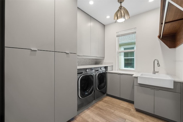 5240 Bentgrass Way, Bradenton, FL 34211 - washroom with independent washer and dryer, recessed lighting, light wood-style floors, and cabinet space