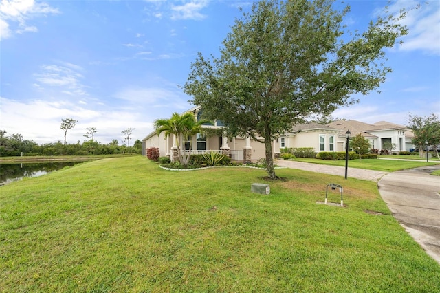 5240 Bentgrass Way, Bradenton, FL 34211 - view of property hidden behind natural elements featuring a front lawn, curved driveway, and a water view