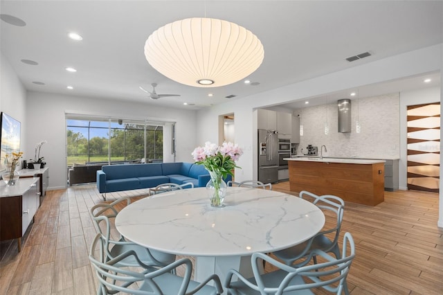 5240 Bentgrass Way, Bradenton, FL 34211 - dining room with light wood-style floors, recessed lighting, and baseboards