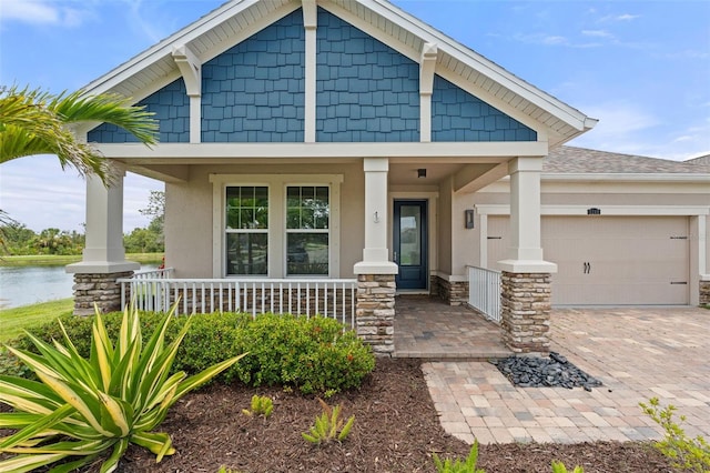 5240 Bentgrass Way, Bradenton, FL 34211 - craftsman-style house with a porch, stucco siding, a garage, and driveway