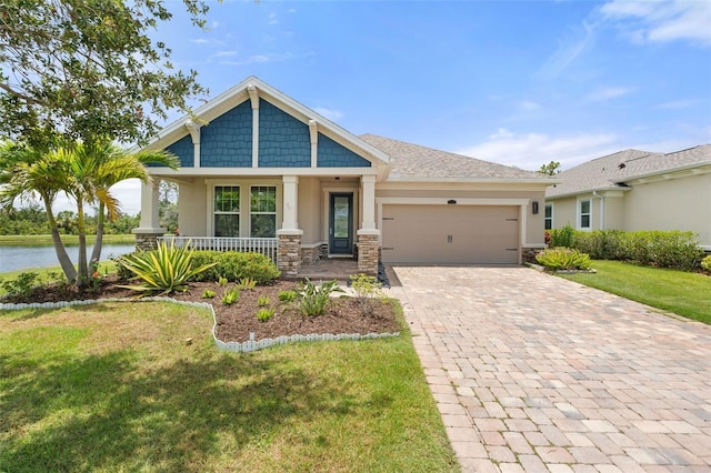 5240 Bentgrass Way, Bradenton, FL 34211 - craftsman inspired home with stucco siding, an attached garage, covered porch, and decorative driveway
