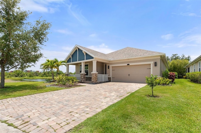 5240 Bentgrass Way, Bradenton, FL 34211 - craftsman house with covered porch, decorative driveway, a garage, and a front yard