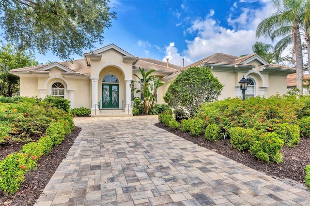 7214 Marlow Pl, University Park, FL 34201 - mediterranean / spanish-style house featuring stucco siding, decorative driveway, and a tile roof