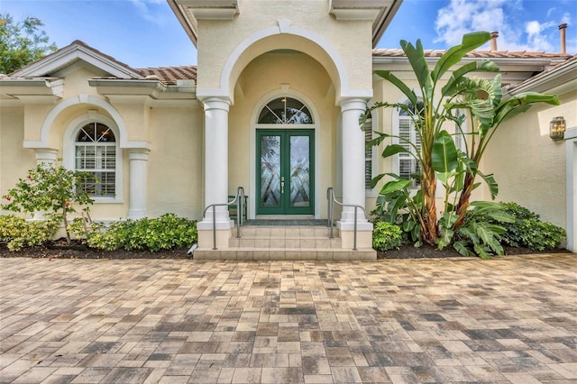 7214 Marlow Pl, University Park, FL 34201 - doorway to property with french doors, a tiled roof, and stucco siding
