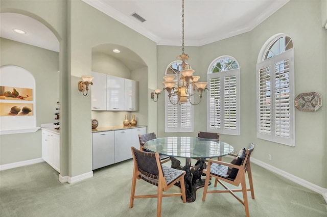 7214 Marlow Pl, University Park, FL 34201 - dining space with light carpet, a chandelier, ornamental molding, and arched walkways