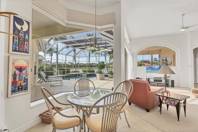 7214 Marlow Pl, University Park, FL 34201 - dining space with a sunroom, tile patterned flooring, a ceiling fan, and arched walkways
