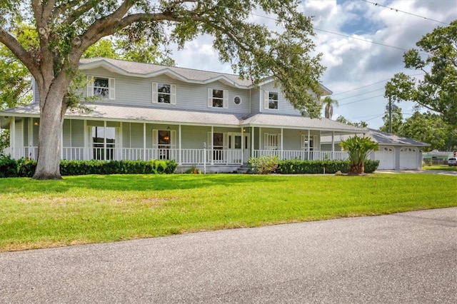 2002 8th St W, Palmetto, FL 34221 - farmhouse with a porch, a garage, a front lawn, and driveway