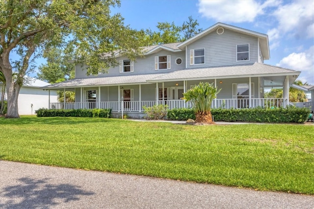 2002 8th St W, Palmetto, FL 34221 - farmhouse inspired home with covered porch, a front yard, and a shingled roof