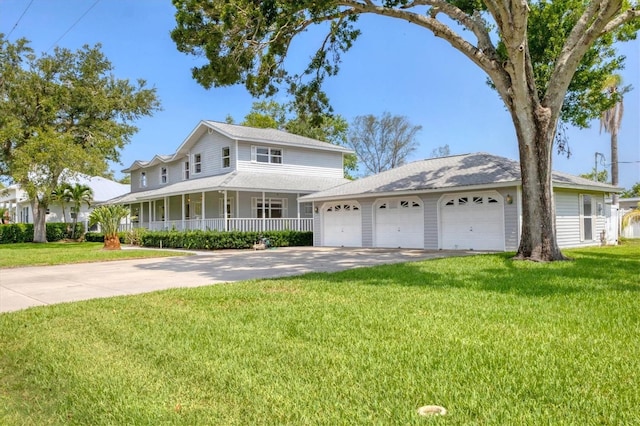 2002 8th St W, Palmetto, FL 34221 - view of front of house featuring concrete driveway, an attached garage, a porch, and a front lawn