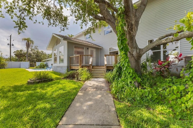 2002 8th St W, Palmetto, FL 34221 - view of front of home with a wooden deck and a swimming pool