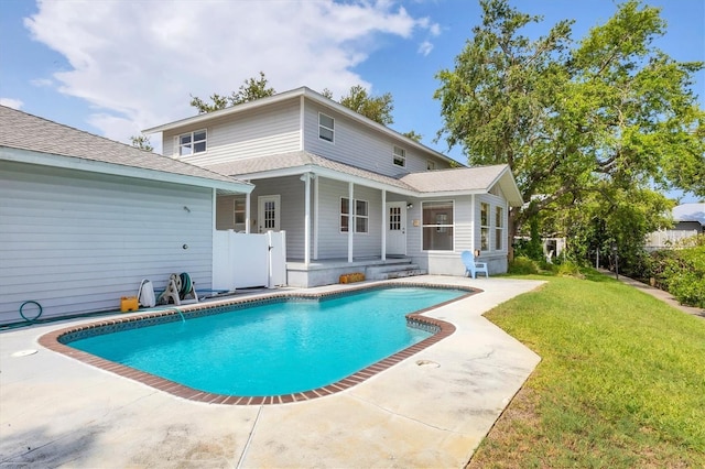 2002 8th St W, Palmetto, FL 34221 - rear view of property with a yard, an outdoor pool, a patio, and a shingled roof