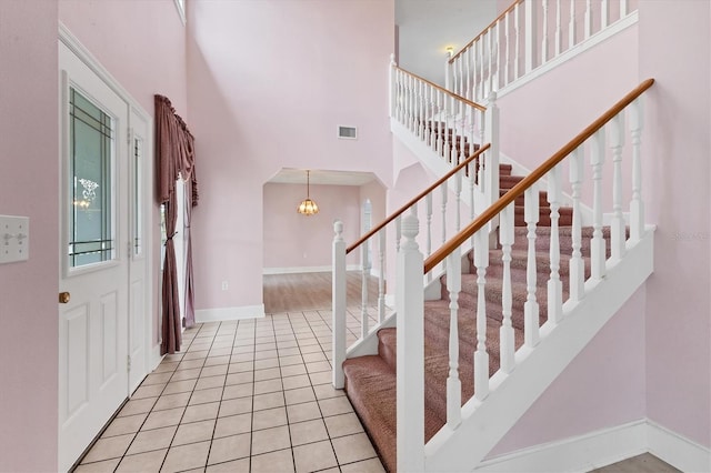 2002 8th St W, Palmetto, FL 34221 - entryway with a towering ceiling, light tile patterned floors, stairway, baseboards, and a chandelier