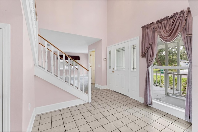 2002 8th St W, Palmetto, FL 34221 - tiled entryway featuring baseboards, stairs, and a high ceiling