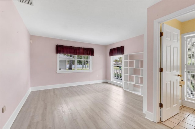 2002 8th St W, Palmetto, FL 34221 - spare room featuring light wood-style floors and baseboards