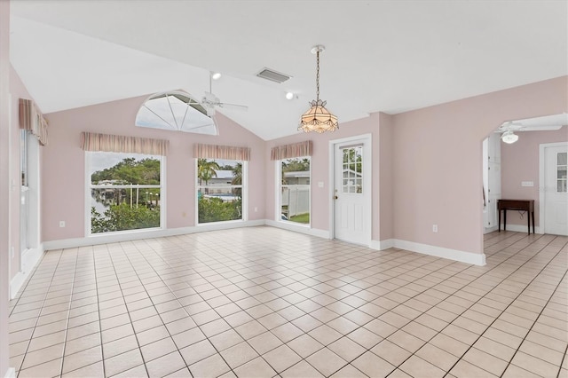 2002 8th St W, Palmetto, FL 34221 - unfurnished living room featuring ceiling fan, light tile patterned flooring, baseboards, and vaulted ceiling