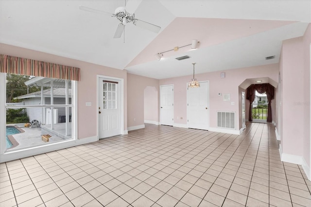 2002 8th St W, Palmetto, FL 34221 - unfurnished living room with a ceiling fan, light tile patterned floors, baseboards, and high vaulted ceiling