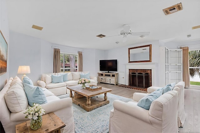 2002 8th St W, Palmetto, FL 34221 - living area featuring light wood-style flooring, ceiling fan, and a brick fireplace