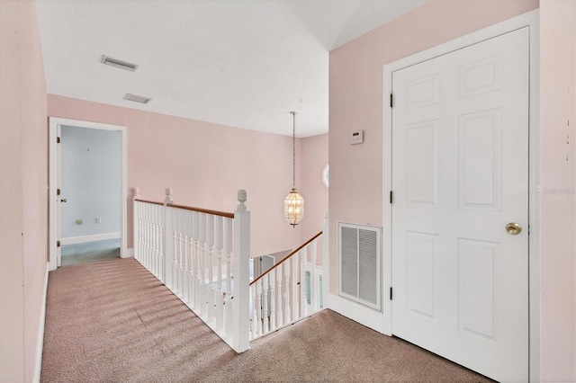 2002 8th St W, Palmetto, FL 34221 - corridor featuring an upstairs landing, carpet floors, baseboards, and a chandelier