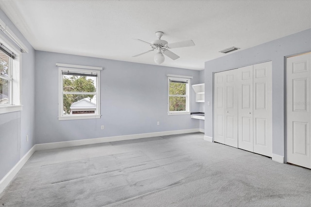 2002 8th St W, Palmetto, FL 34221 - unfurnished bedroom with carpet flooring, baseboards, a ceiling fan, and a closet