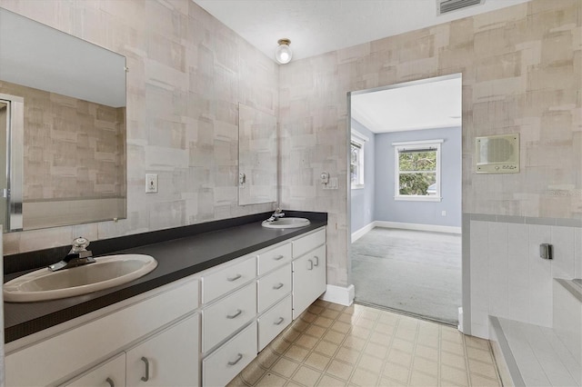 2002 8th St W, Palmetto, FL 34221 - bathroom with tile walls, double vanity, and baseboards