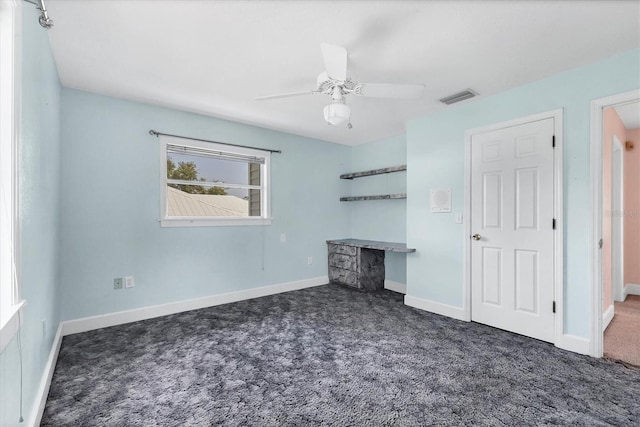 2002 8th St W, Palmetto, FL 34221 - unfurnished bedroom featuring carpet, baseboards, and a ceiling fan
