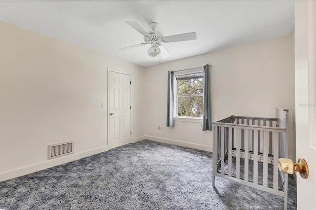 2002 8th St W, Palmetto, FL 34221 - unfurnished bedroom featuring carpet flooring, baseboards, a ceiling fan, and a crib
